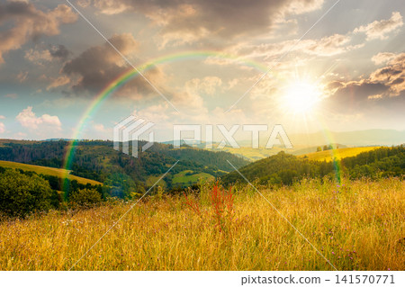 sunset over countryside mountain landscape in summer. lush grassy pasture on a hill near forest. rural outdoor adventure background. alpine highland of ukraine under the rainbow sunset over countryside mountain landscape in summer. lush grassy pasture on a hill near forest. rural outdoor adventure background. alpine highland of ukraine under the rainbow 141570771