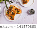 Delicious puff pastry buns with cheese and asparagus on a plate on the table top view 141570863