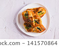 Close up of delicious puff pastry buns with cheese and asparagus on a plate on the table top view 141570864