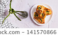 Asparagus baked in puff pastry with cheese and sesame seeds on a plate on the table top view web banner 141570866