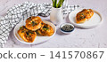 Asparagus baked in puff pastry with cheese and sesame seeds on a plate on the table web banner 141570867