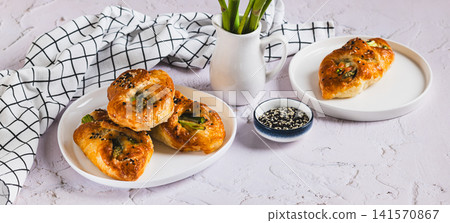 Asparagus baked in puff pastry with cheese and sesame seeds on a plate on the table web banner Asparagus baked in puff pastry with cheese and sesame seeds on a plate on the table web banner 141570867