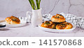 Delicious puff pastry buns with cheese and asparagus on a plate on the table web banner 141570868