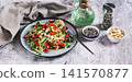 A delicious salad of glass noodles, fried bell peppers, cilantro, and nuts on a plate on the table web banner 141570877