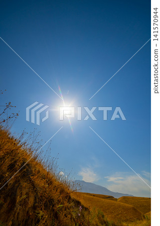 Bright Sun Over Dry Grass Hillside in Kyrgyzstan Bright Sun Over Dry Grass Hillside in Kyrgyzstan 141570944