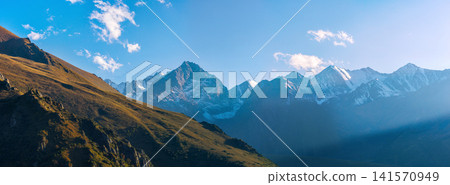 Golden Mountain Slope with Snow-Capped Peaks in Kyrgyzstan Golden Mountain Slope with Snow-Capped Peaks in Kyrgyzstan 141570949