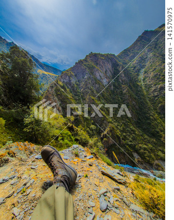 Hiking Boot on Rocky Ledge Overlooking Mountain Valley Hiking Boot on Rocky Ledge Overlooking Mountain Valley 141570975