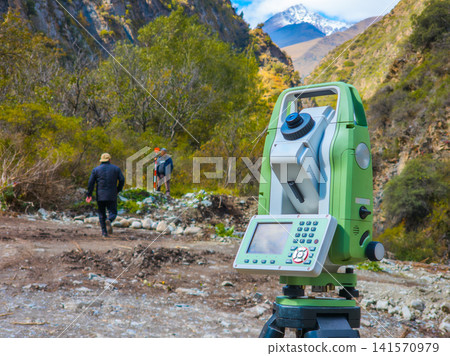 Surveyors Using Total Station in Kyrgyzstan Mountains Surveyors Using Total Station in Kyrgyzstan Mountains 141570979