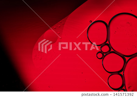 Oil bubbles creating an abstract pattern in a vibrant red liquid Oil bubbles creating an abstract pattern in a vibrant red liquid 141571392