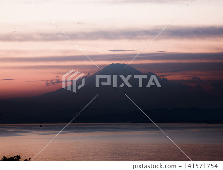 View of the silhouete of Mount Fuji from Enoshima Island on the sunset View of the silhouete of Mount Fuji from Enoshima Island on the sunset 141571754