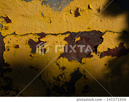 Close-up of aged yellow peeling paint on rusty metal surface with cracked texture and natural weathering. Distressed background, vintage patina. Close-up of aged yellow peeling paint on rusty metal surface with cracked texture and natural weathering. Distressed background, vintage patina. 141571939