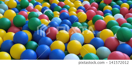 close up of large pile of colorful plastic kids pool balls in various colors blue, yellow, green, and red close up of large pile of colorful plastic kids pool balls in various colors blue, yellow, green, and red 141572012