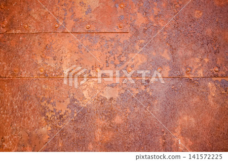 A rusty metal plate. Old-world architecture, heritage conservation, and decorative design themes. A rusty metal plate. Old-world architecture, heritage conservation, and decorative design themes. 141572225