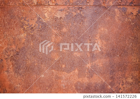 A rusty metal plate. Old-world architecture, heritage conservation, and decorative design themes. A rusty metal plate. Old-world architecture, heritage conservation, and decorative design themes. 141572226