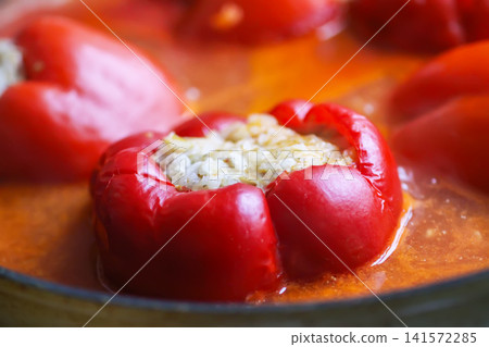 Red bell pepper stuffed with rice and ground meat served as a homemade dish. Traditional comfort food, family cooking. Red bell pepper stuffed with rice and ground meat served as a homemade dish. Traditional comfort food, family cooking. 141572285