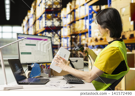 Asian man scanning awb labels next to brain graphics for AI-generated tracking software, using scanner to register tracking numbers barcodes. Artificial intelligence supporting shipments and orders. Asian man scanning awb labels next to brain graphics for AI-generated tracking software, using scanner to register tracking numbers barcodes. Artificial intelligence supporting shipments and orders. 141572490