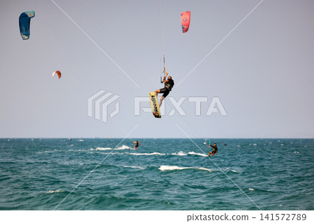 Kitesurfer performs a high Big Air jump over the sea in Nha Trang, Vietnam Kitesurfer performs a high Big Air jump over the sea in Nha Trang, Vietnam 141572789