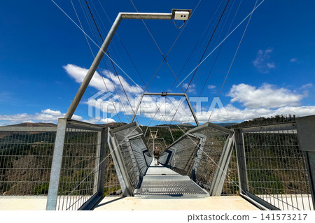 Arouca 516 suspension bridge crossing a dramatic valley in Portugal, showcasing modern engineering, adventure tourism, geometric design, scenic landscapes, and outdoor exploration Arouca 516 suspension bridge crossing a dramatic valley in Portugal, showcasing modern engineering, adventure tourism, geometric design, scenic landscapes, and outdoor exploration 141573217