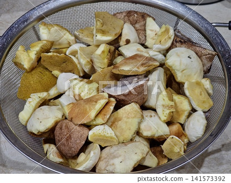 Cleaned and Sliced Wild Bolete Mushrooms in Metal Colander Cleaned and Sliced Wild Bolete Mushrooms in Metal Colander 141573392