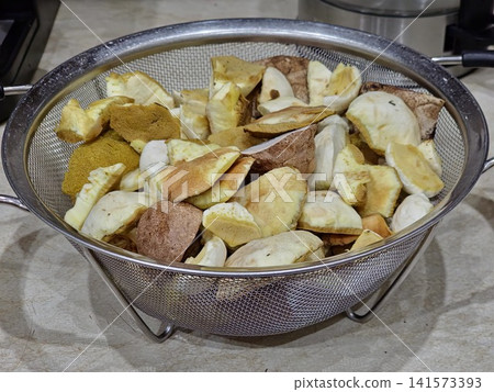Assorted Cleaned Forest Mushrooms in Kitchen Colander Assorted Cleaned Forest Mushrooms in Kitchen Colander 141573393