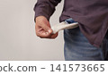 Adult man showing empty pocket indicating he is broke and has no money. Financial crisis, debt, poor, lose a job and bankrupt business concept. 141573665