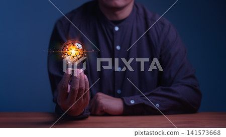 Man holding a glowing light bulb with a brain inside. This concept illustrates artificial intelligence, smart business innovation, human creativity, technology, and brilliant mind ideas. 141573668