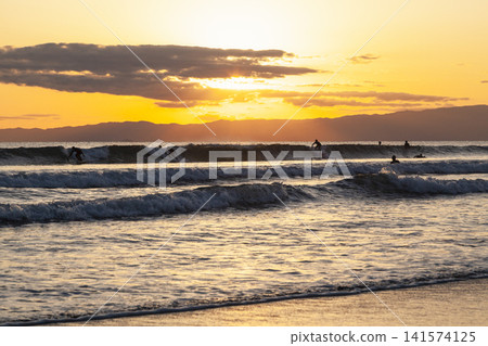 Surfing in the evening at Kugenuma Beach, Shonan. Surfing in the evening at Kugenuma Beach, Shonan. 141574125