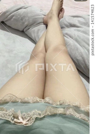 The thighs of a woman sleeping in her bedroom The thighs of a woman sleeping in her bedroom 141574623