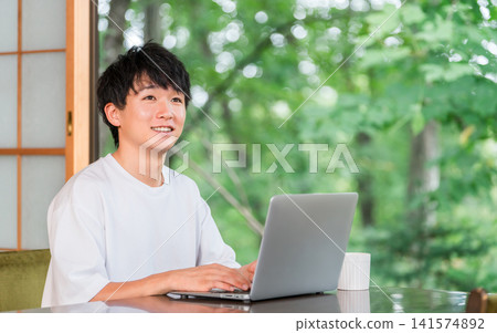 A young man who is an address hopper and does workation/remote work. A young man who is an address hopper and does workation/remote work. 141574892