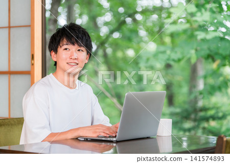 A young man who is an address hopper and does workation/remote work. A young man who is an address hopper and does workation/remote work. 141574893