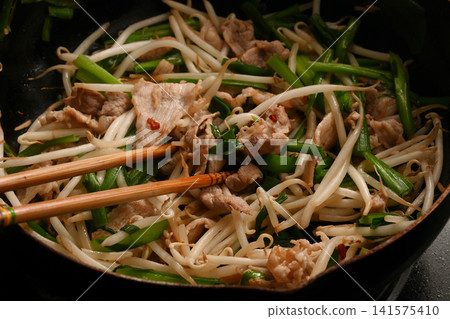 Pork chive bean sprouts being cooked Pork chive bean sprouts being cooked 141575410