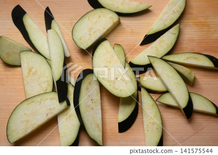 Eggplant cut on a cutting board Eggplant cut on a cutting board 141575544
