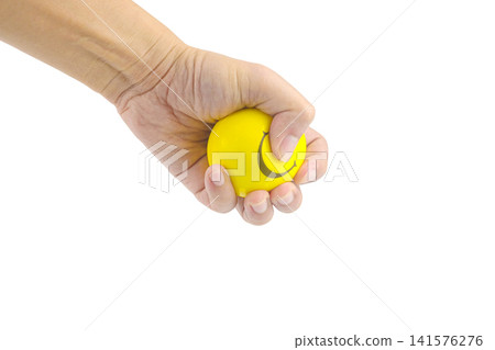 Hands of a young man with a gentle personality He exhibits stressful behavior from work, and he squeezes the yellow ball expressing emotion, anger, displeasure. Medical concepts and emotional regulati Hands of a young man with a gentle personality He exhibits stressful behavior from work, and he squeezes the yellow ball expressing emotion, anger, displeasure. Medical concepts and emotional regulati 141576276