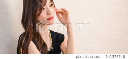 A woman wearing accessories, jewelry, and a necklace. A woman wearing accessories, jewelry, and a necklace. 141576340