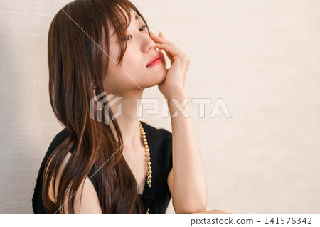 A woman wearing accessories, jewelry, and a necklace. A woman wearing accessories, jewelry, and a necklace. 141576342