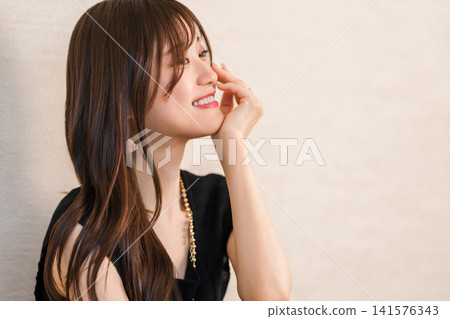 A woman wearing accessories, jewelry, and a necklace. A woman wearing accessories, jewelry, and a necklace. 141576343