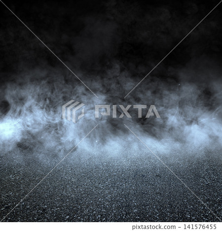 A dark asphalt texture background covered with a thick layer of blue-tinted dramatic fog and smoke, creating a mysterious atmospheric stage scene. Halloween and horror background 141576455