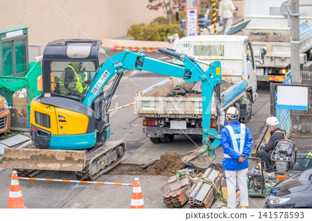 Seismic reinforcement work on combined sewer pipes (rehabilitation method), removal of asphalt pavement, road excavation, workers. Seismic reinforcement work on combined sewer pipes (rehabilitation method), removal of asphalt pavement, road excavation, workers. 141578593
