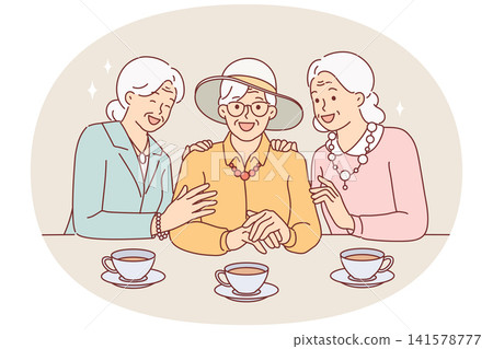 Elderly women drink tea and laugh, rejoicing at long-awaited meeting, dressed in elegant clothes Elderly women drink tea and laugh, rejoicing at long-awaited meeting, dressed in elegant clothes 141578777