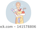 Business man in housewife apron is doing housework and cleaning or cooking after returning from work 141578806