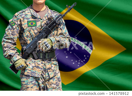 Brazil flag with soldier holding assault rifle Brazil flag with soldier holding assault rifle 141578912