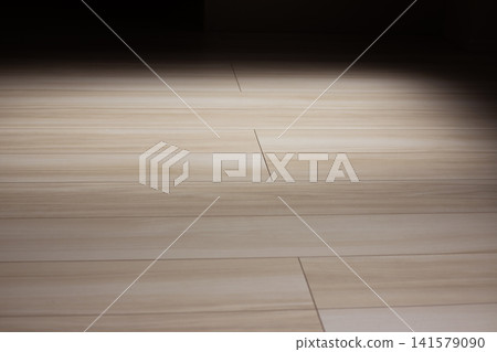 The wood-grain flooring background features a beautiful contrast between dark lighting and soft shadows. The wood-grain flooring background features a beautiful contrast between dark lighting and soft shadows. 141579090
