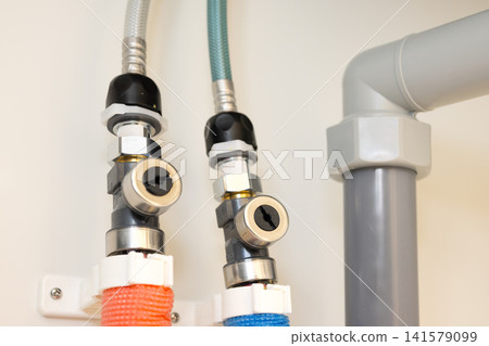 Plumbing pipes and shut-off valves for water supply installed on the wall under the sink. Plumbing pipes and shut-off valves for water supply installed on the wall under the sink. 141579099