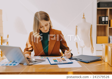Logistics, small business woman with checklist for stock, clothes order or retail inventory management. Shipping, writing or person at ecommerce startup store for sme delivery with fashion designer Logistics, small business woman with checklist for stock, clothes order or retail inventory management. Shipping, writing or person at ecommerce startup store for sme delivery with fashion designer 141579526