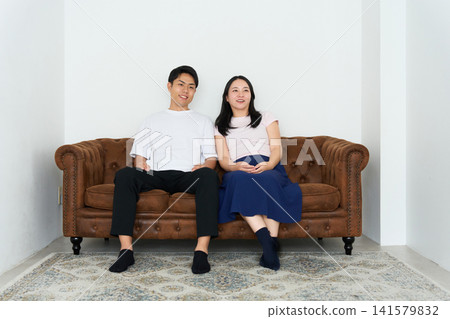 A young man and woman look into each other's eyes and talk. 141579832