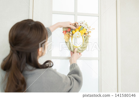 A smiling woman holding a Shimenawa wreath A smiling woman holding a Shimenawa wreath 141580146