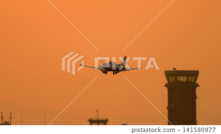 A Japan Air Self-Defense Force T-7 training aircraft takes off at dusk. A Japan Air Self-Defense Force T-7 training aircraft takes off at dusk. 141580977