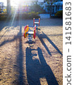 Park playground equipment illuminated by the morning sun 141581683