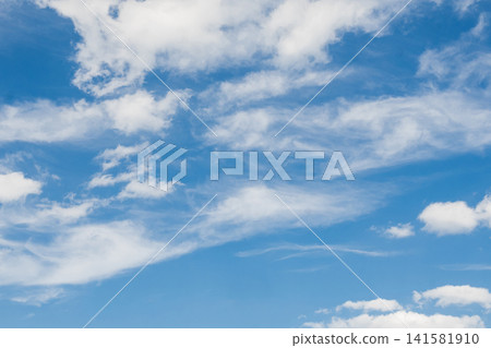 Soft white cirrus and cumulus clouds scattered across a vivid blue sky Soft white cirrus and cumulus clouds scattered across a vivid blue sky 141581910