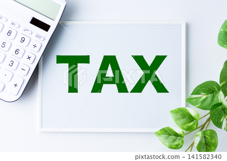 Whiteboard with the word "TAX" Whiteboard with the word "TAX" 141582340